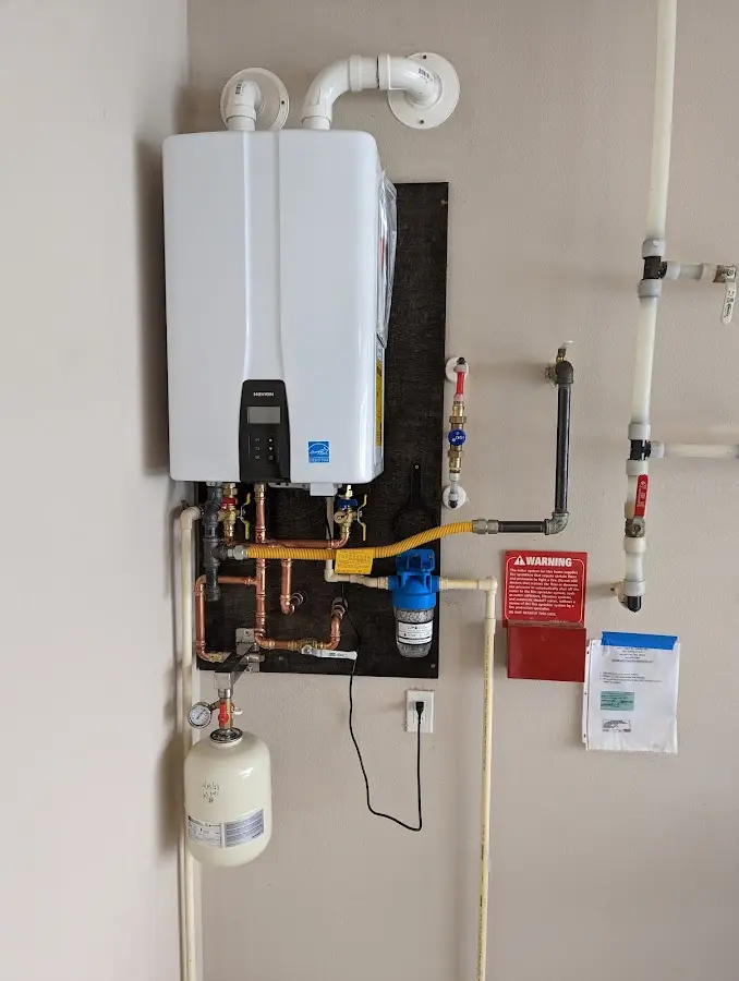 Professional plumber installing copper piping in a Dryden home